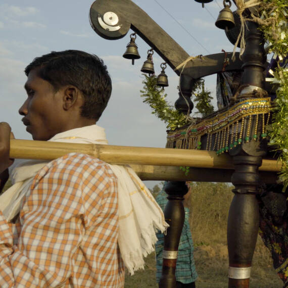 Dharua men carrying the deity on shoulder