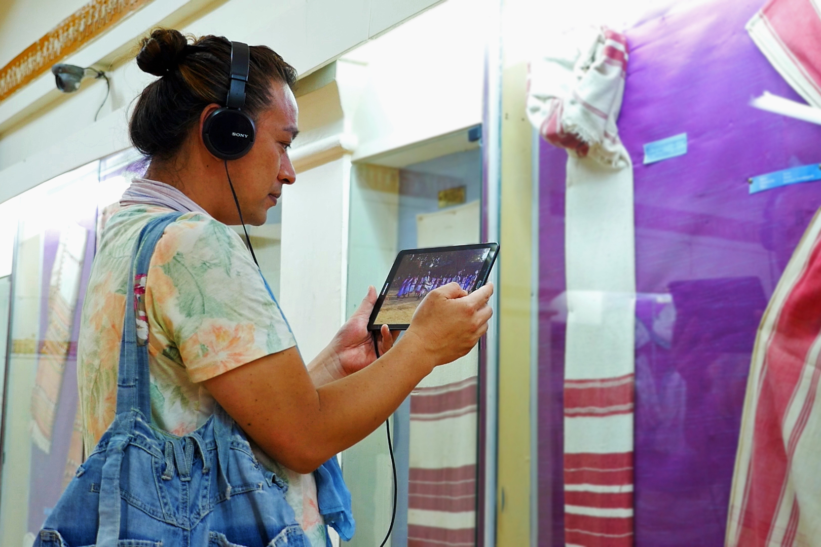 A visitor enjoying Multimedia Tour on tablet at Tribal Museum, Bhubaneswar